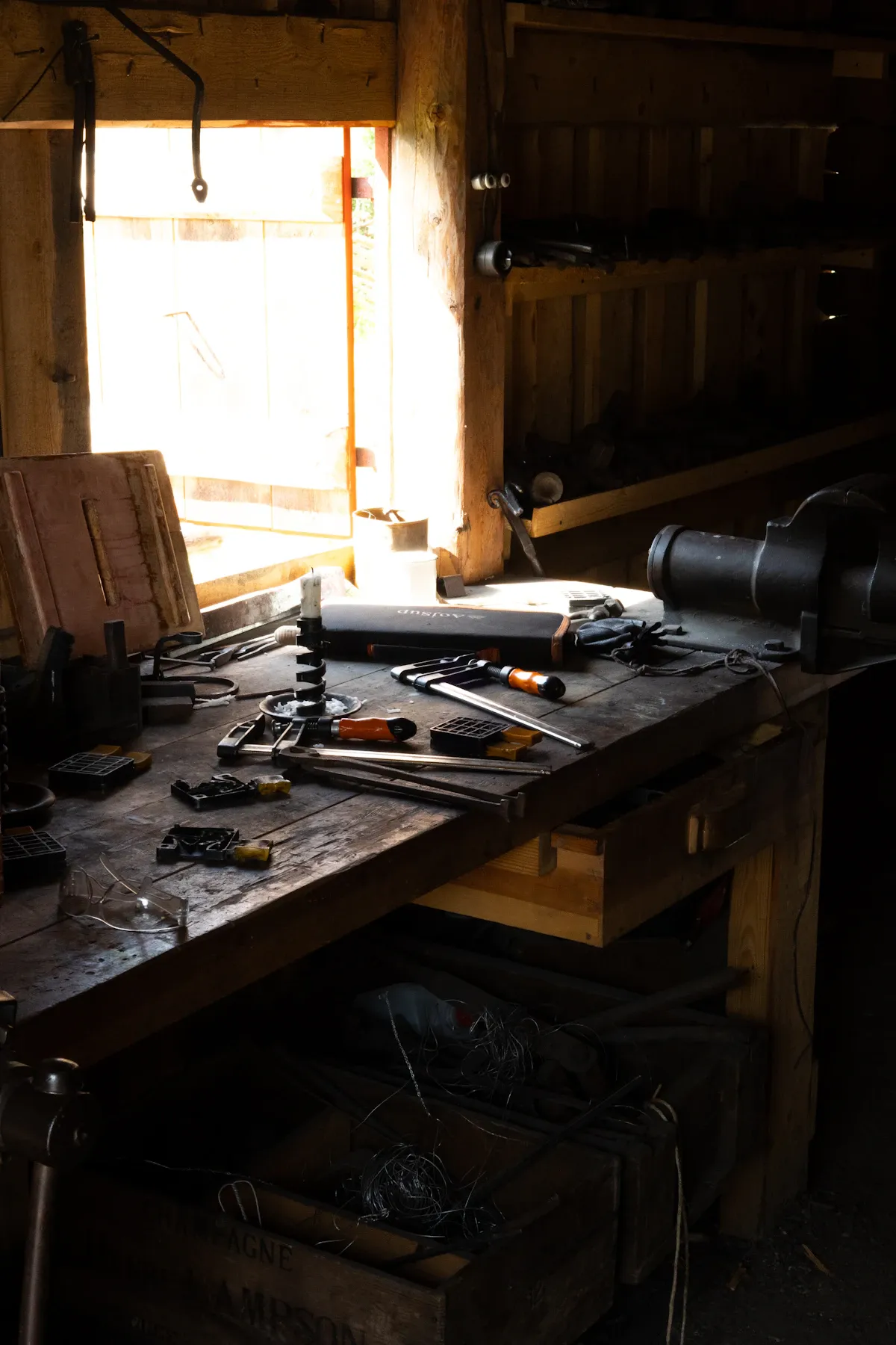 Assorted skilled trade tools and modern industrial machinery arranged in a well-lit professional workshop workspace.